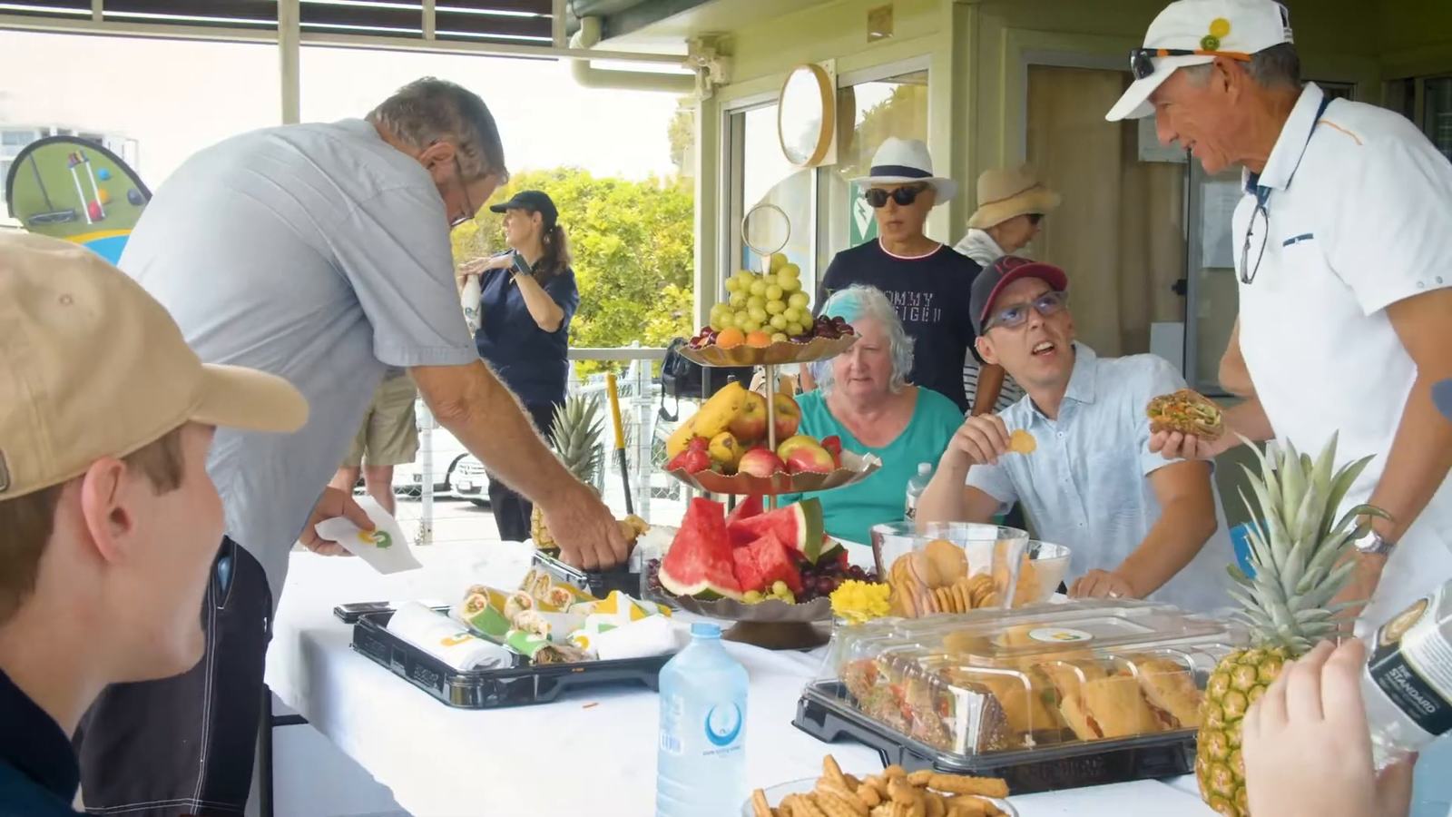 Fruit platters and plates of food laid out for players on a clubhouse verandah
